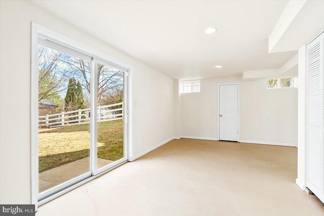 spare room with recessed lighting, baseboards, and concrete floors