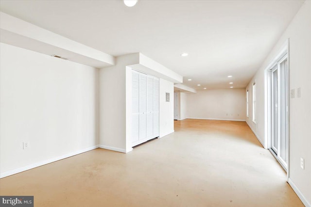 spare room featuring recessed lighting, visible vents, concrete floors, and baseboards