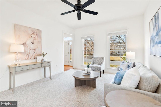 sitting room with baseboards, carpet, and ceiling fan