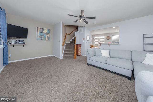 living room with visible vents, baseboards, ceiling fan, stairs, and carpet flooring