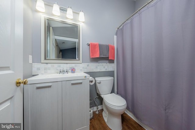 bathroom featuring vanity, toilet, and wood finished floors