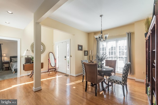 dining space with a chandelier, recessed lighting, light wood-style flooring, and baseboards