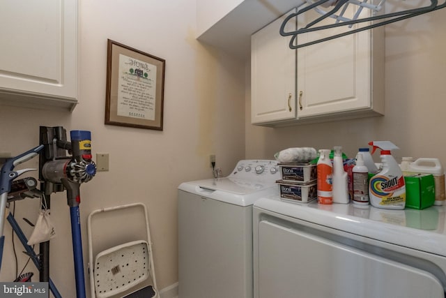 washroom with cabinet space and washing machine and dryer