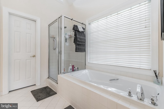 bathroom with tile patterned floors, a stall shower, and a garden tub