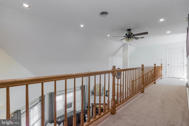 hallway with visible vents, recessed lighting, and light colored carpet