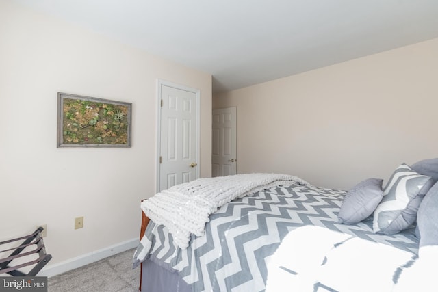 bedroom with light carpet and baseboards