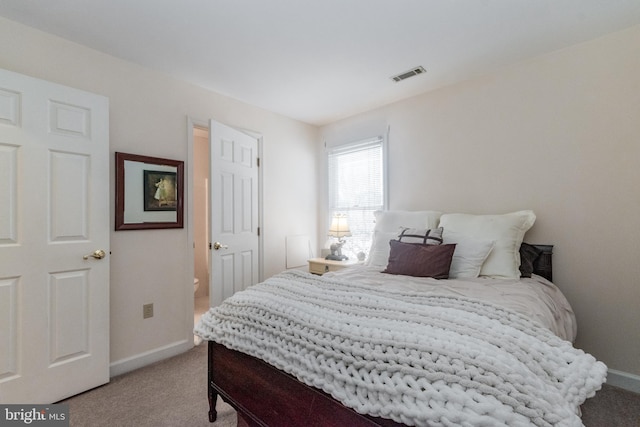 bedroom featuring visible vents, baseboards, and light colored carpet