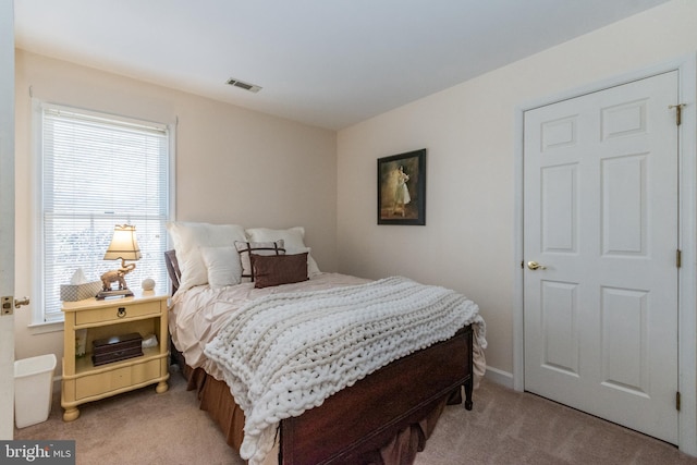 carpeted bedroom with visible vents