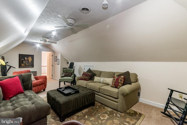 carpeted home theater featuring a ceiling fan, baseboards, visible vents, vaulted ceiling, and a textured ceiling