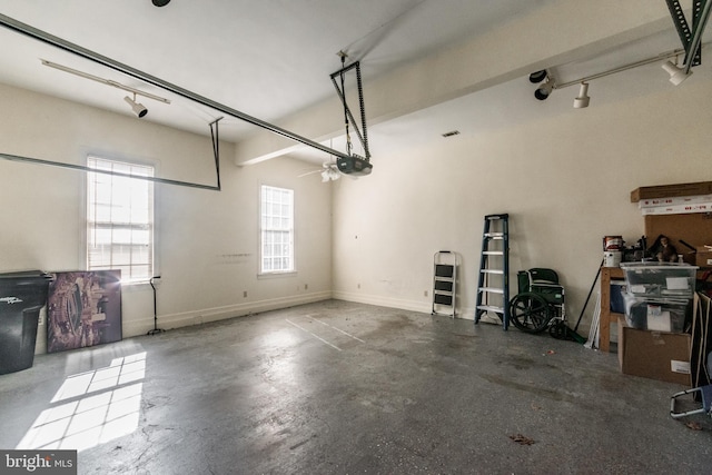 garage with a garage door opener and baseboards