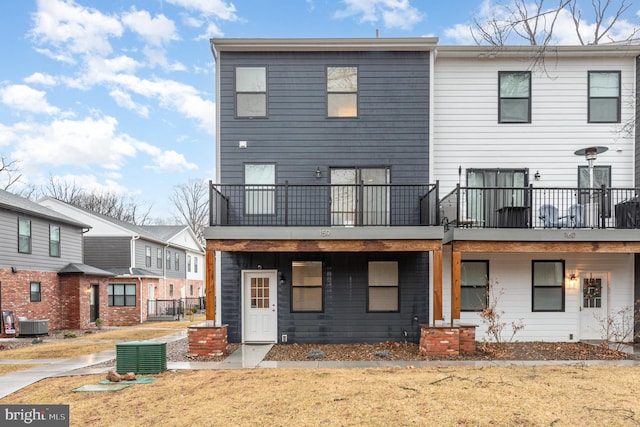 back of house featuring a yard and central AC unit