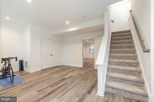 interior space with light wood finished floors, baseboards, visible vents, and recessed lighting