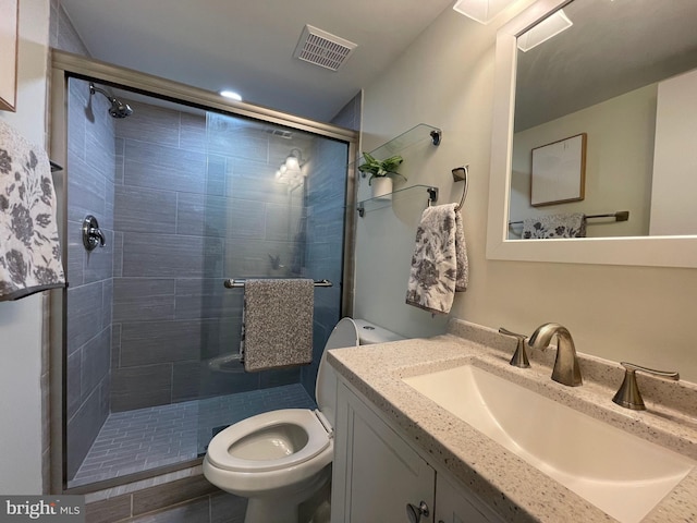 bathroom with toilet, a stall shower, visible vents, and vanity