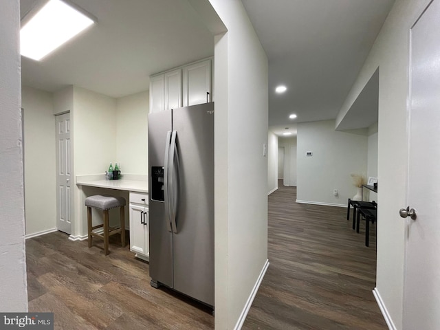 hall featuring dark wood-style floors, recessed lighting, and baseboards