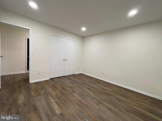 unfurnished bedroom with dark wood-type flooring, recessed lighting, and baseboards