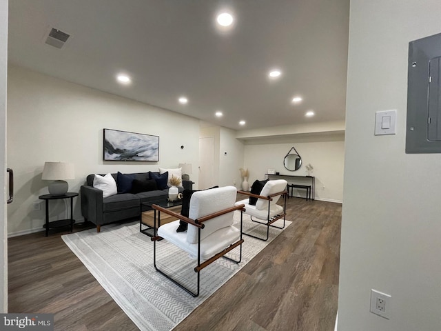 living area featuring dark wood finished floors, electric panel, and recessed lighting