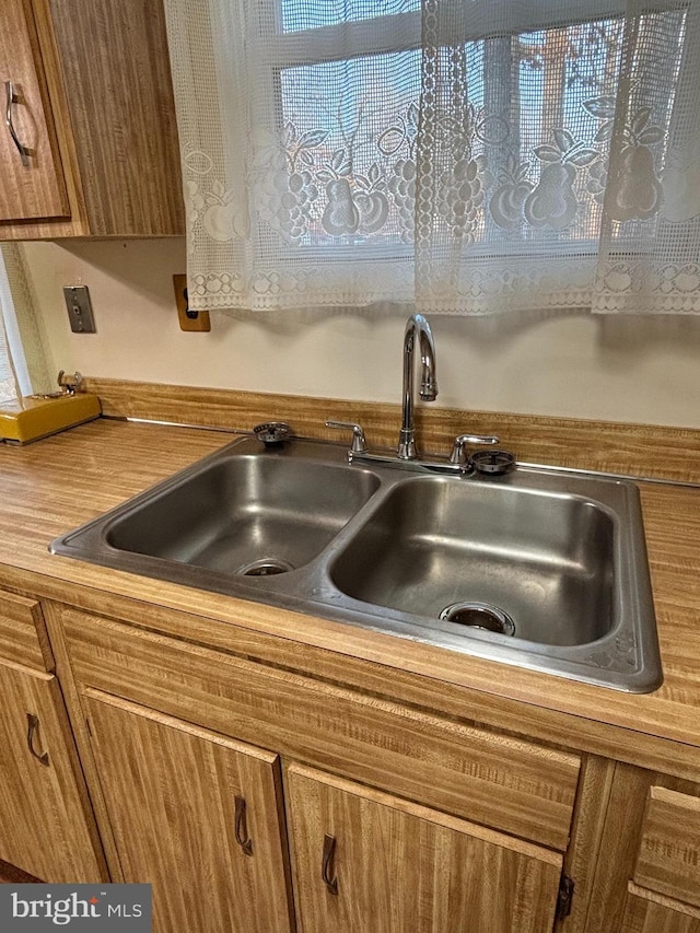 details with a sink and brown cabinets