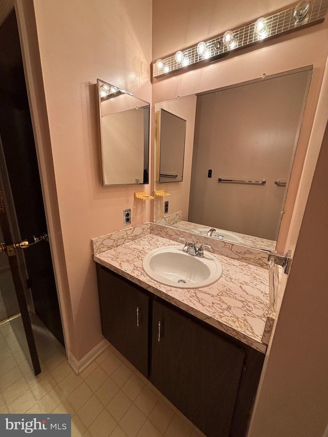 bathroom with vanity and baseboards