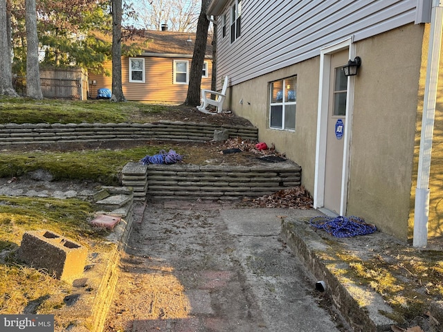 view of home's exterior featuring fence and stucco siding