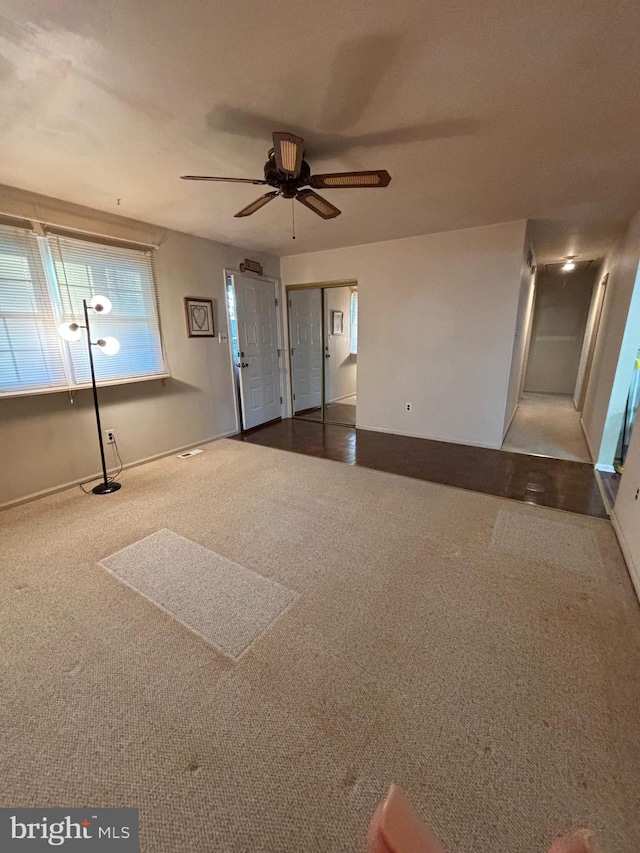 unfurnished room with carpet floors and ceiling fan