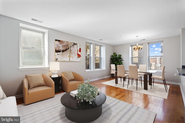 interior space featuring light wood-style floors, plenty of natural light, and visible vents