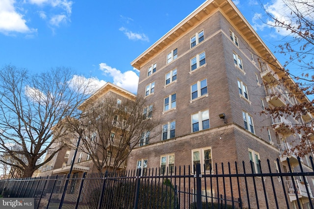 view of building exterior with fence