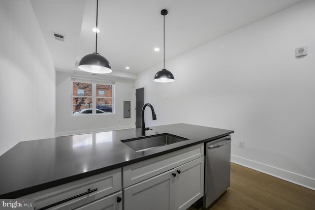 kitchen with visible vents, white cabinets, dishwasher, dark countertops, and a sink