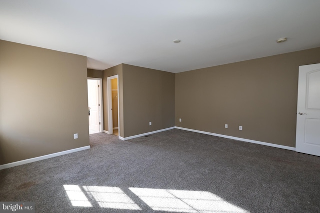 carpeted empty room with baseboards