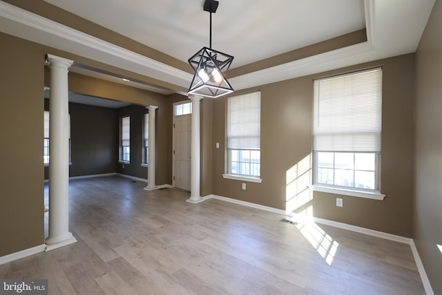 interior space featuring ornate columns, visible vents, and light wood finished floors