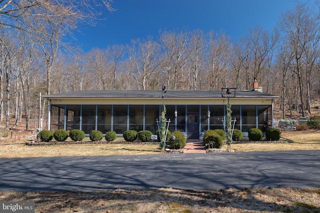 view of front facade with a sunroom