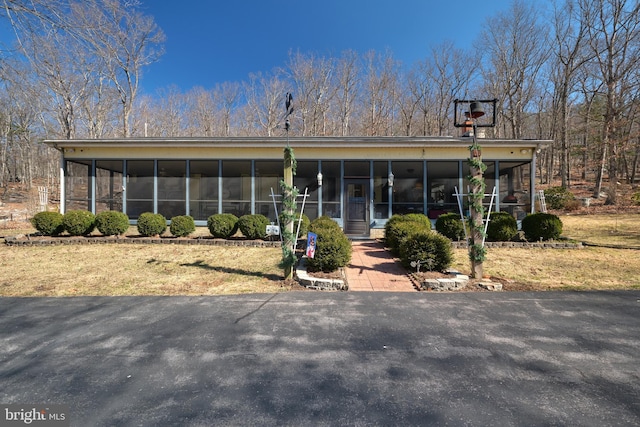 view of front facade with a sunroom