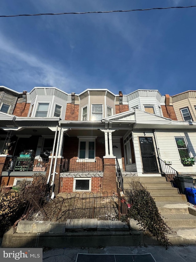 townhome / multi-family property featuring brick siding