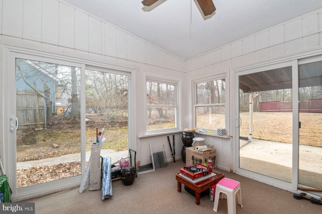 sunroom / solarium featuring lofted ceiling and a ceiling fan