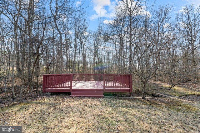 wooden deck with a lawn