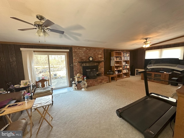 interior space with wood walls, ceiling fan, and a wealth of natural light