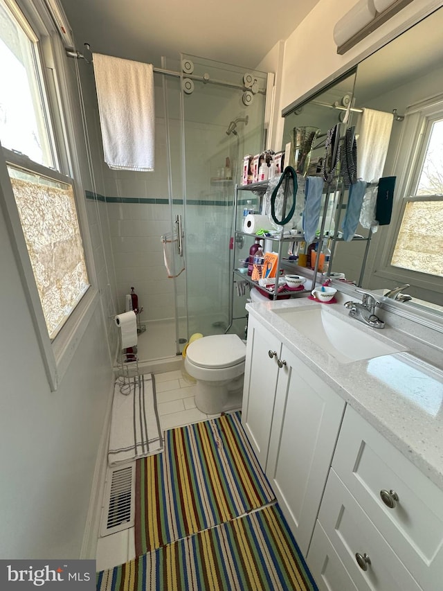 full bath featuring visible vents, a shower stall, toilet, and vanity