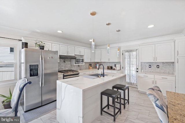 kitchen featuring marble finish floor, appliances with stainless steel finishes, white cabinets, and crown molding