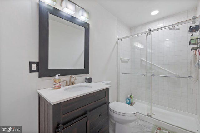 bathroom with marble finish floor, a shower stall, toilet, and vanity