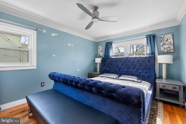 bedroom with ceiling fan, crown molding, baseboards, and wood finished floors