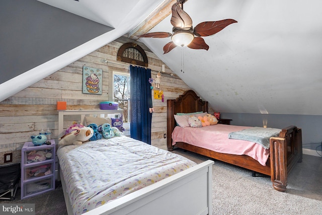 carpeted bedroom featuring lofted ceiling with beams, wooden walls, and a ceiling fan