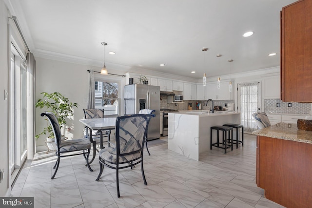 dining space with marble finish floor, ornamental molding, and recessed lighting