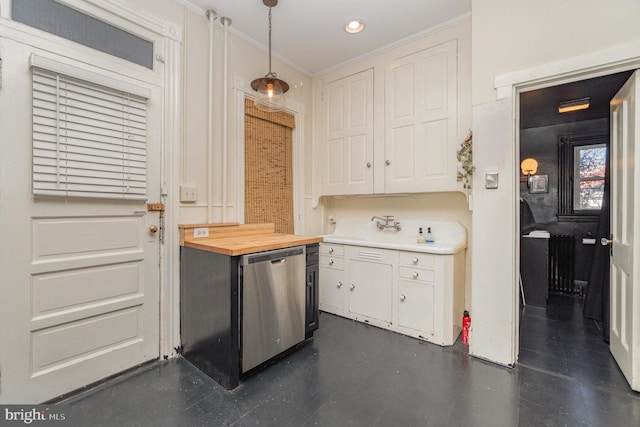 kitchen featuring butcher block counters, crown molding, white cabinets, and stainless steel dishwasher