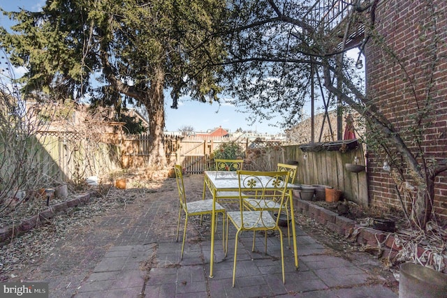 view of patio / terrace with a fenced backyard and outdoor dining space