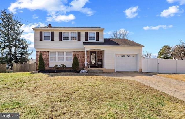 view of front of home with a front lawn, decorative driveway, fence, a garage, and brick siding