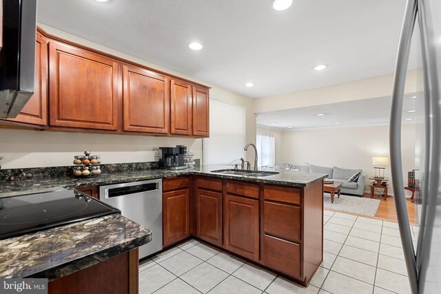 kitchen with a sink, stainless steel dishwasher, recessed lighting, a peninsula, and light tile patterned floors