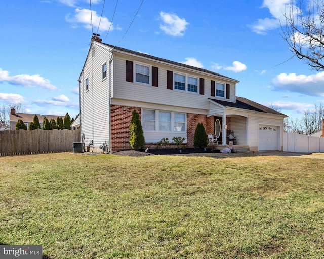 view of front facade with cooling unit, an attached garage, a front yard, and fence