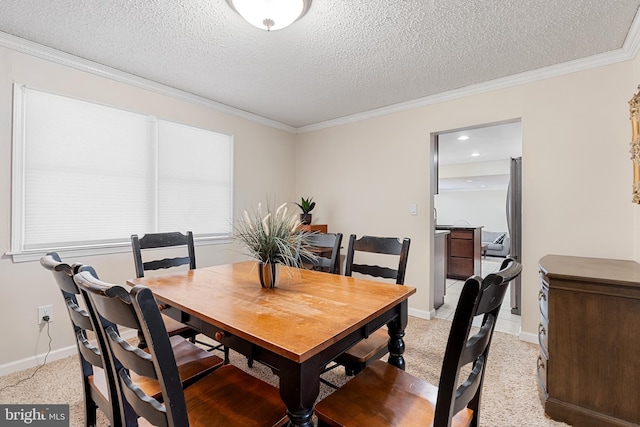 dining area with a textured ceiling, light colored carpet, baseboards, and ornamental molding