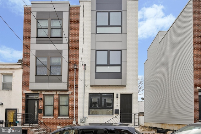 view of front of home featuring brick siding