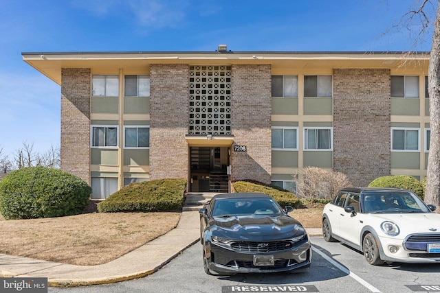 view of building exterior featuring uncovered parking