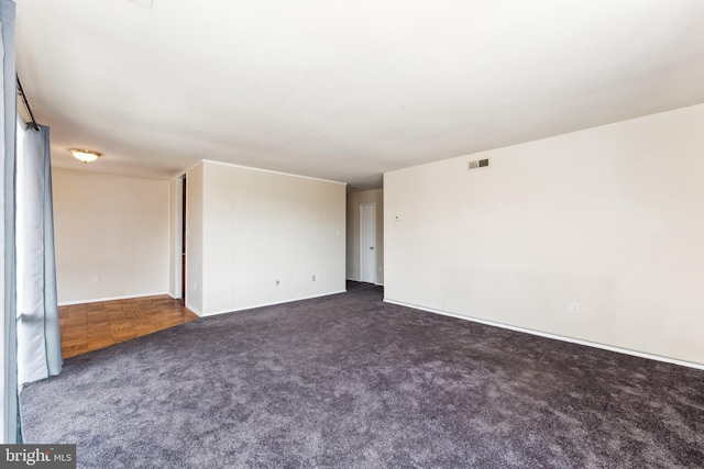 unfurnished room with visible vents and carpet flooring